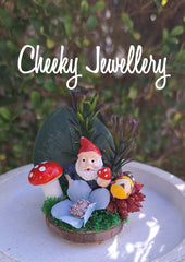 The cutest mini Gnome themescapes mini on a wood slice, with crystal.