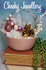 Cute as a button easter winter garden, with bronze bunny with pink and snowy setting.